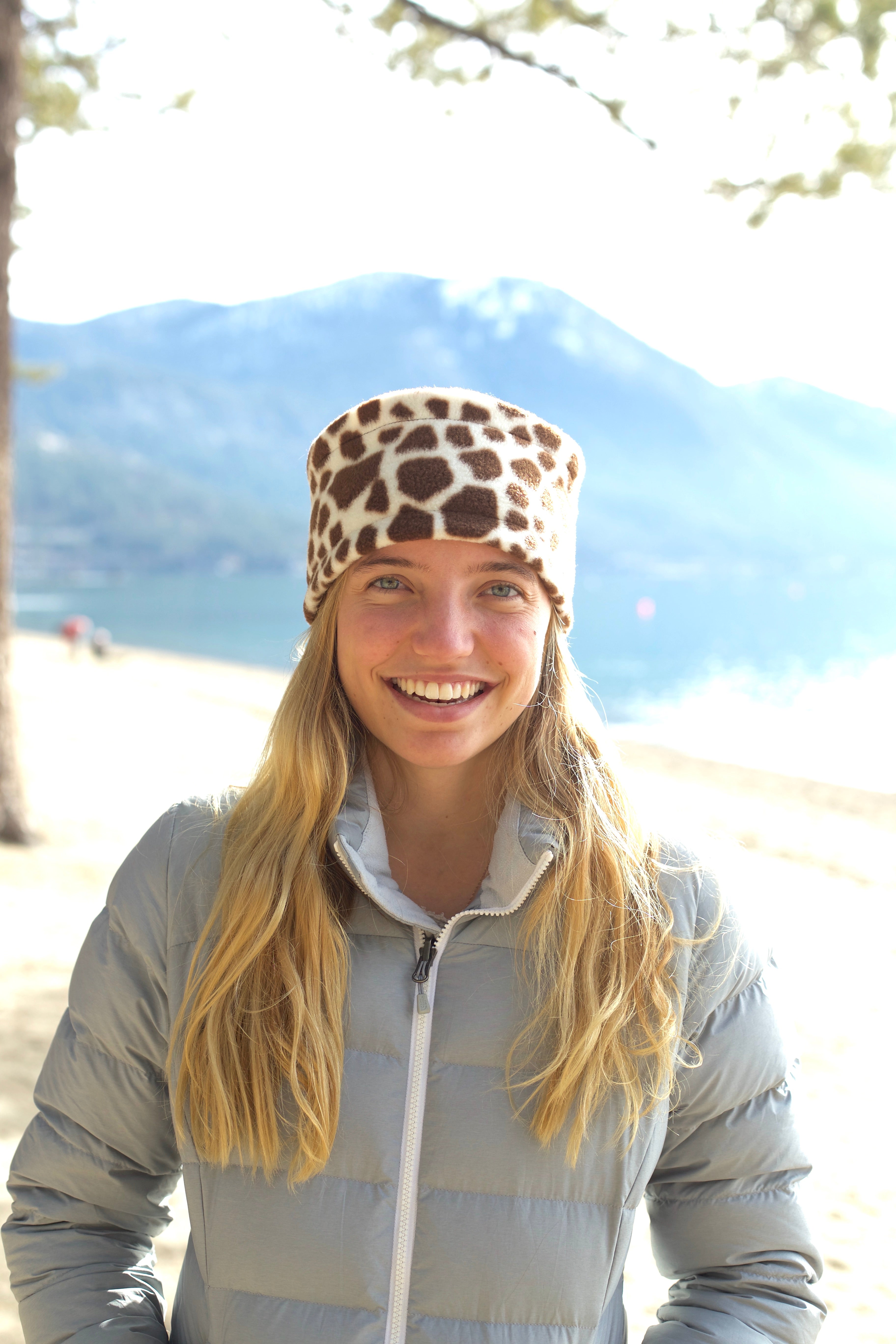 Girl wearing Warm Hat. Fleece hat by Luvcali. Giraffe print.